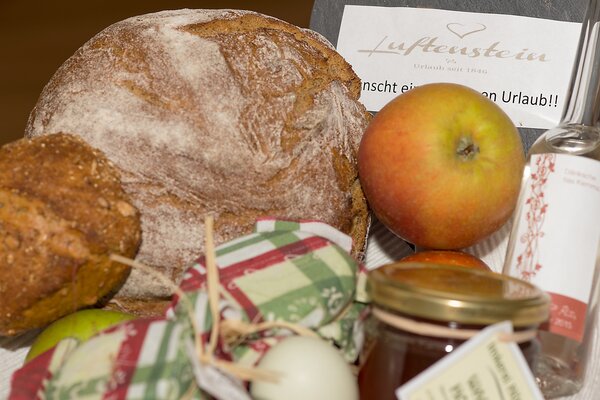 Willkommenskorb im S' Mauthäusl Luftenstein mit frischem Brot, Apfel, Marmelade und Grußkarte.