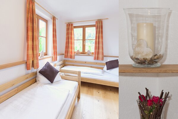 Gemütliches Schlafzimmer der Ferienwohnung Ochsenhorn mit zwei Einzelbetten aus Holz in St. Martin.
